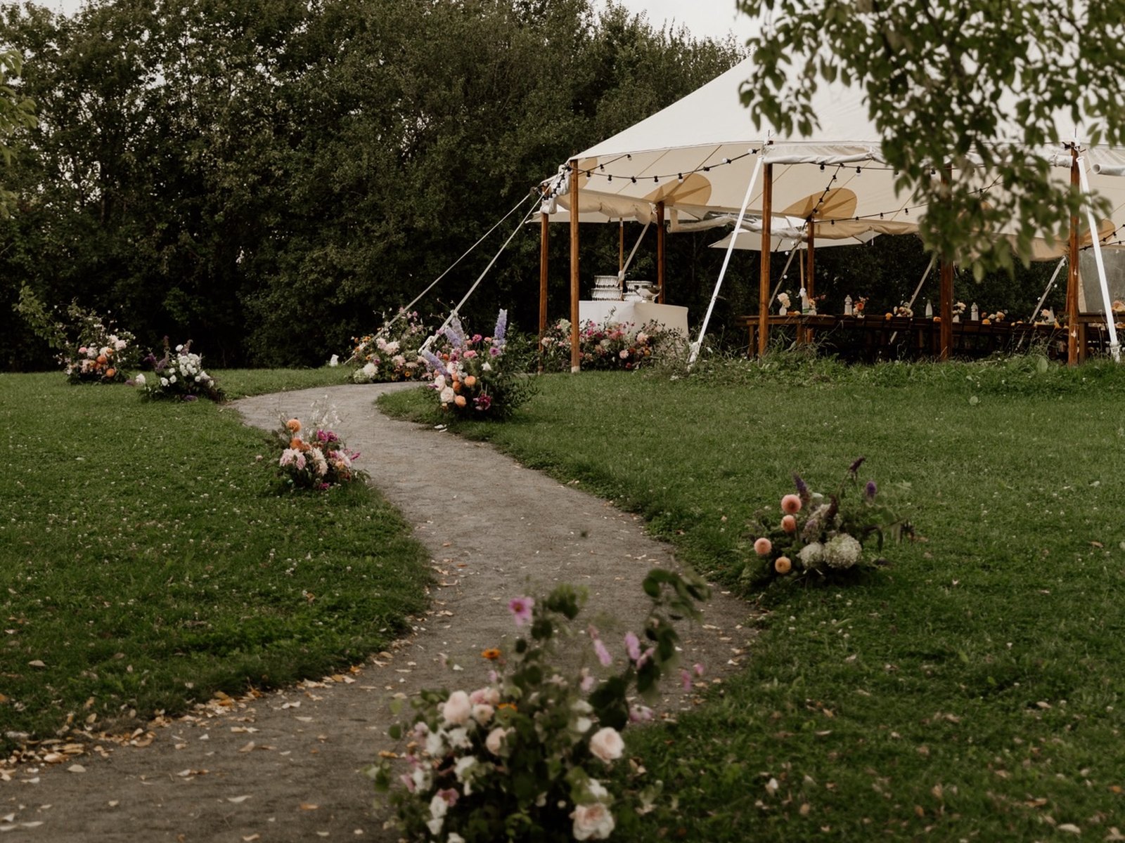 Flower-lined path leading to the marquee in the grounds
