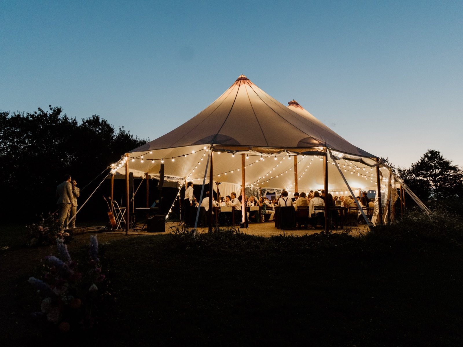 The marquee glowing at dusk during dinner