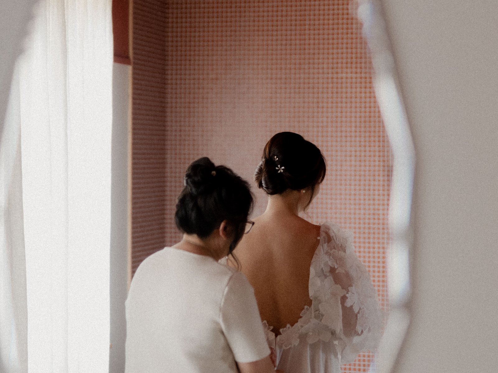 The bride getting ready, reflected in the mirror