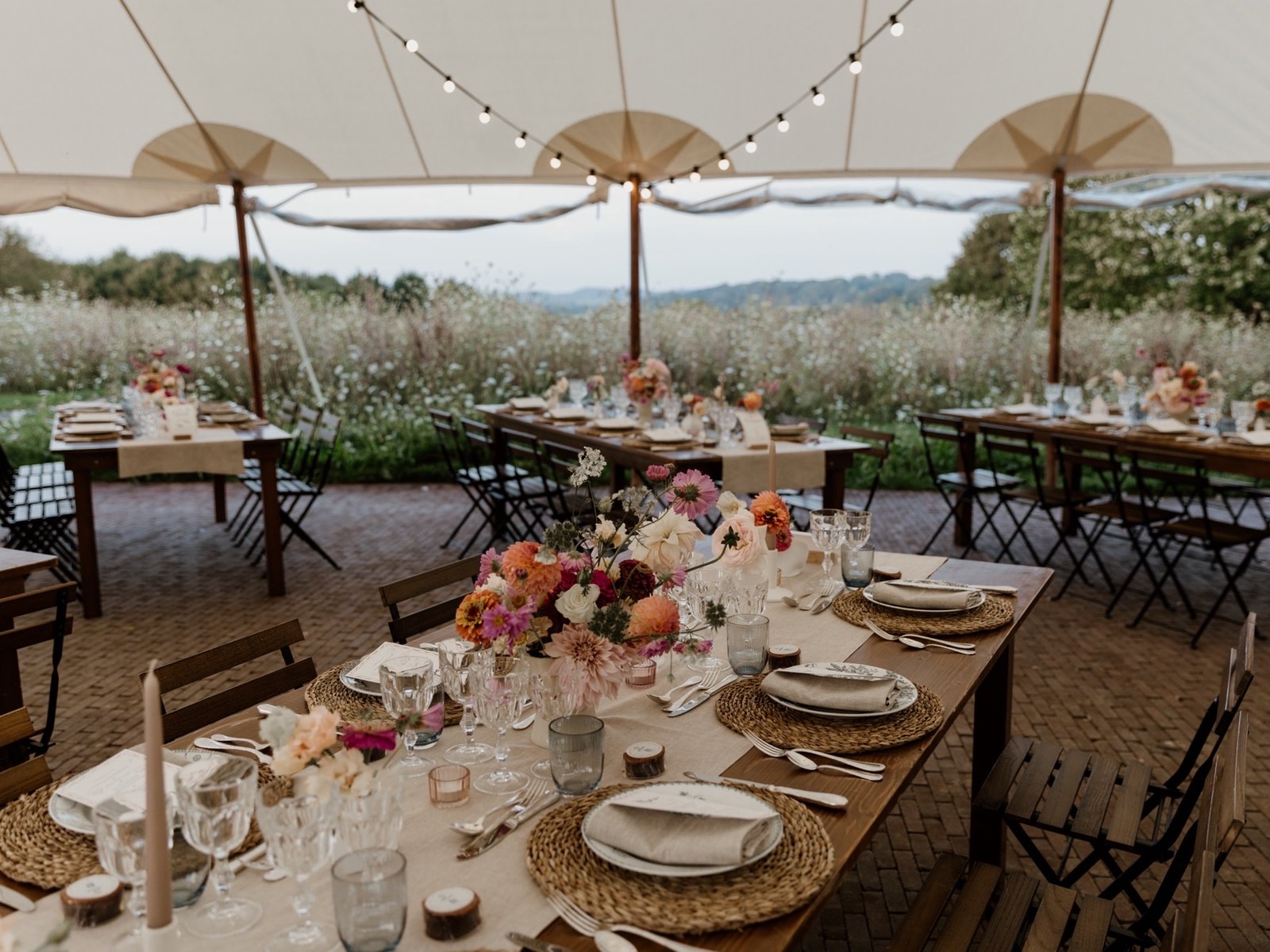 Tables set under the marquee, facing the valley