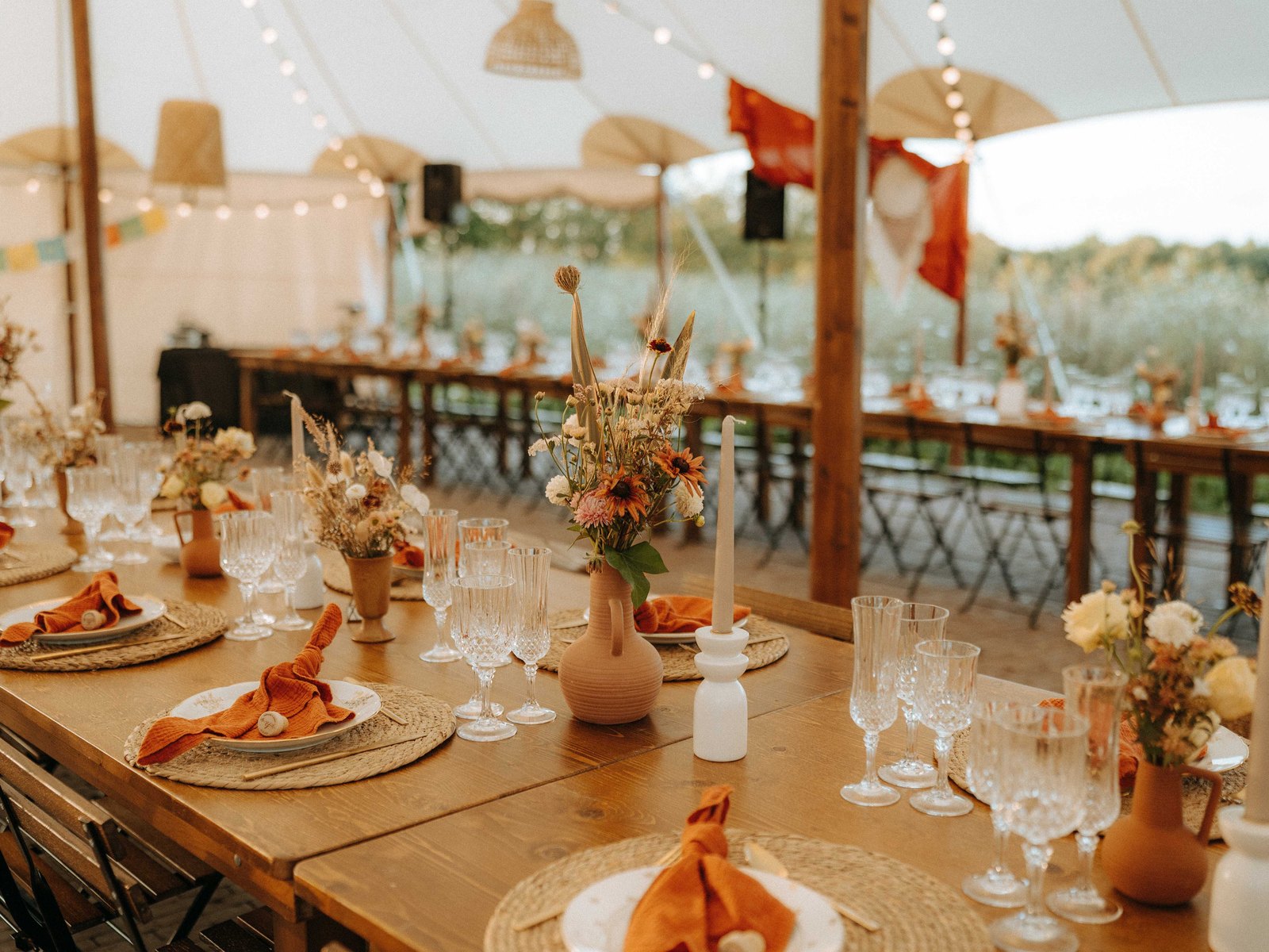 Terracotta-toned tablescape set under the marquee