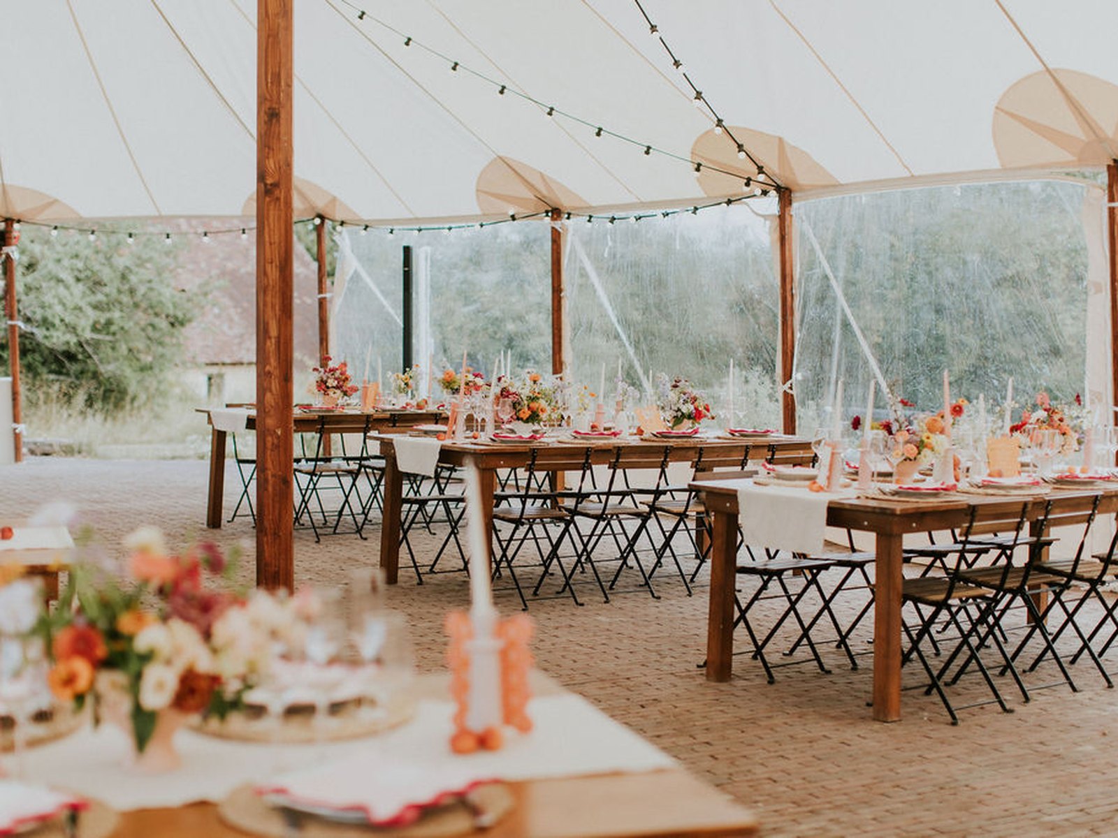 Long flower-decked tables set under the marquee
