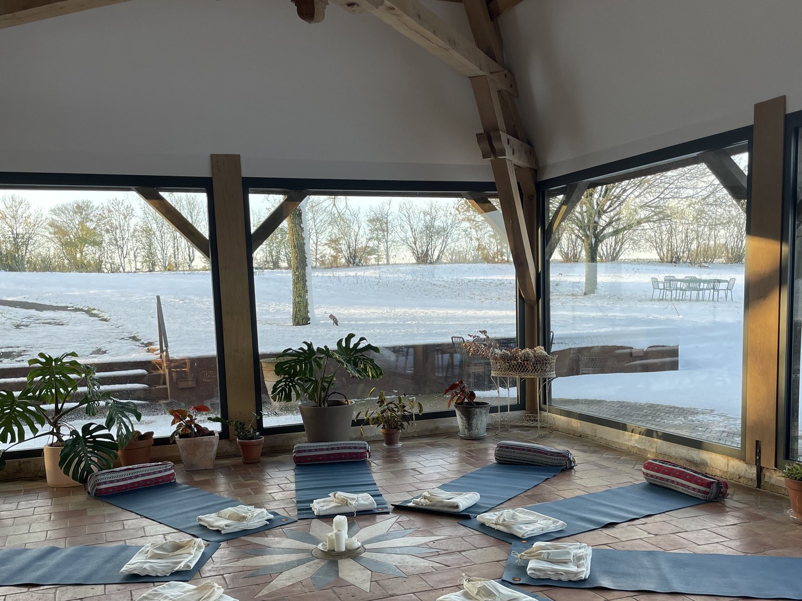 Yoga mats laid out in a mandala facing the snowy grounds